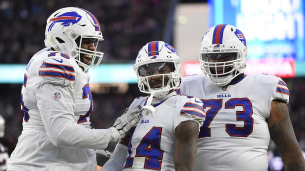 Dec 26, 2021; Foxborough, Massachusetts, USA; Buffalo Bills wide receiver Stefon Diggs (14) reacts with offensive tackle Daryl Williams (75) and offensive tackle Dion Dawkins (73) after catching a pass for a first down during the second half against the New England Patriots at Gillette Stadium. Mandatory Credit: Bob DeChiara-USA TODAY Sports